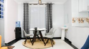 a dining room with a table and chairs at Maya Homes in Naivasha