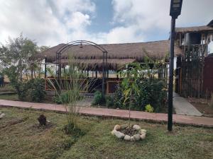 a garden with a building with a tree in the yard at AVA Resort, Kaziranga in Bokakhat