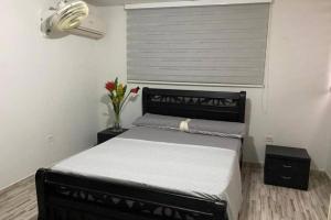 um quarto com uma cama e um vaso de flores em Apartamento en El Rodadero, Santa Marta em Santa Marta