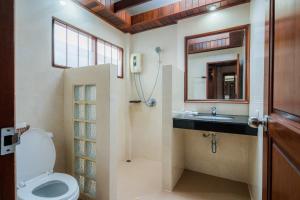 a bathroom with a toilet and a sink and a mirror at Long Beach Lodge, Chaweng Beach, Koh Samui in Chaweng +143 photos