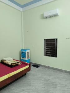 a bedroom with a bed and a air conditioner at HomeStay Ông Vinh 