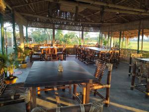 a dining room with tables and chairs in a restaurant at AVA Resort, Kaziranga in Bokakhat