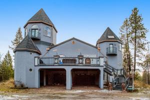 a large house with a balcony on top of it at The Castle in Columbia Falls