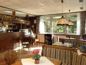 a restaurant with a bar and a dining room at Park Hotel Miramonti in San Martino di Castrozza