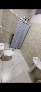 a bathroom with two sinks and a shower at Complejo francesca in Paso de la Patria