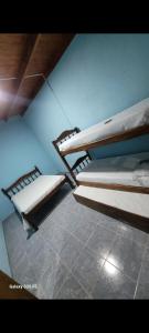 two bunk beds in a room with a tile floor at Complejo francesca in Paso de la Patria