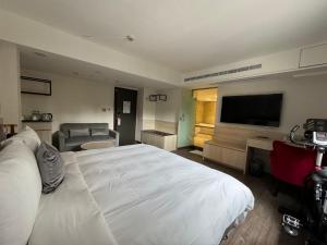 Ένα ή περισσότερα κρεβάτια σε δωμάτιο στο Delight Hotel
