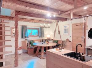 a kitchen and living room with a table and a couch at s'Zuhaus in Kirchbichl