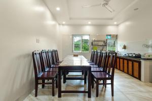 a dining room with a table and chairs in a kitchen at Victoria Phu Quoc hotel 1 minute walking to beach, near to night market in Phú Quốc
