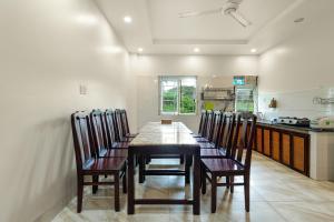 a dining room with a table and chairs in a kitchen at Victoria Phu Quoc hotel Beachfront Night market in Phu Quoc +16 photos