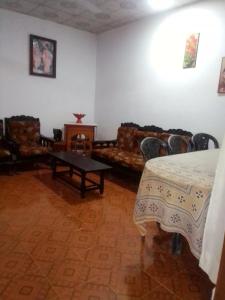 a living room with couches and a table in a room at VA Villa Hikkaduwa in Hikkaduwa