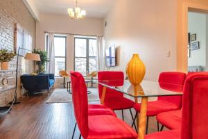 a dining room with a table and red chairs at McCormick Place 420 friendly 3BR/2BA with Optional parking for up to 8 guests in Chicago
