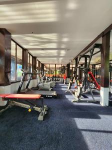 a gym with several treadmills and machines at Club One Seven Gaymen Chiang Mai in Chiang Mai