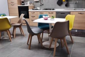 uma cozinha com uma mesa branca e quatro cadeiras em Civico 4 em Campagnano di Roma