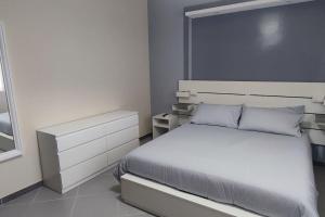 um quarto branco com uma cama e uma janela em Civico 4 em Campagnano di Roma