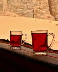 two glasses of red tea sitting on a table at Lucas Camp Wadi Rum in Disah +93 photos
