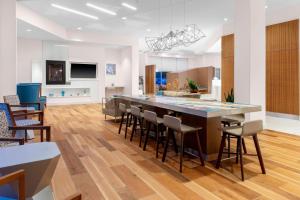 a kitchen with a large island with bar stools at Residence Inn by Marriott Boston Burlington in Burlington