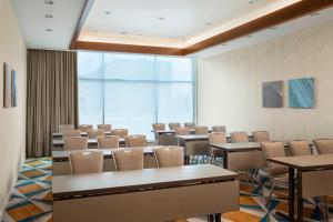 a conference room with tables and chairs and a large window at Residence Inn by Marriott Boston Burlington in Burlington +32 photos