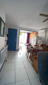 eine Küche mit einer blauen Tür und einem weißen Fliesenboden in der Unterkunft Appartement climatisé avec grande terrasse SUD in Gruissan