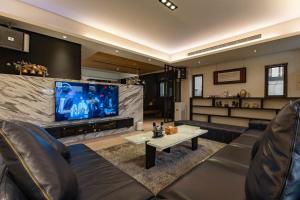 a living room with couches and a large screen tv at Rainbow in Ji'an