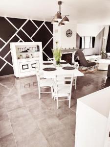 a dining room with a white table and chairs at La Portel'Heurt in Le Portel