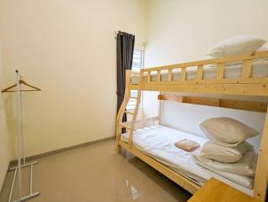 a bedroom with two bunk beds in a room at Lovina B2/12A at Ansley Park Spacious+Netflix in Batam Center