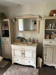 a bathroom with a sink and a mirror at La fabrique des petits bonheurs in Dieulefit