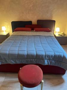 a bed with a red stool and a red chair at Wave Home 2 in Castel Gandolfo