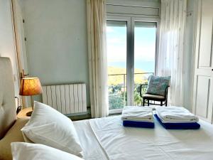 - une chambre avec un lit, une chaise et une fenêtre dans l'établissement Impresionantes Vistas Mar en el centro de Begur, à Begur
