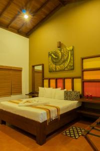 a bedroom with a large bed in a room at Radawana Wasala Nature Resort in Radawana