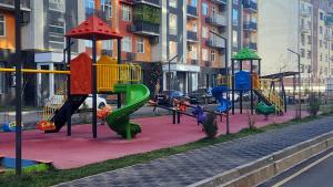 a playground on the side of a city street at Assalom Apartment 6 in Tashkent