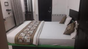 a large bed in a room with at Hotel RJ 15 jaisalmer in Jaisalmer