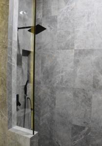 a shower with a glass door in a bathroom at Moniere House in Kasri