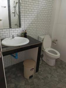 a bathroom with a sink and a toilet at Brown Andaman Krabi in Krabi town