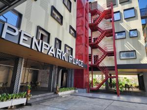 a facade of a building with a red fire escape at Penpark Place in Bangkok