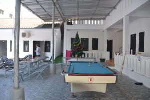 a pool table in a room with a christmas tree at Top One Backpacker Hostel in Vientiane