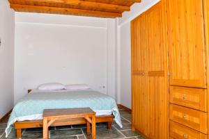 a bedroom with a bed and a wooden cabinet at Forest View House Seta in Séta
