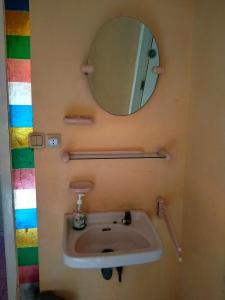 a bathroom with a sink and a mirror at Roemah Sakinah in Ciguntur