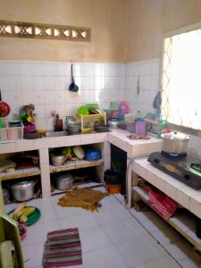 a kitchen filled with lots of clutter at Roemah Sakinah in Ciguntur