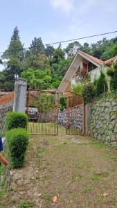 a fence in front of a house at Roemah Sakinah in Ciguntur