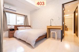 a bedroom with a bed and a desk and a sink at Downtown Apartment/ SHIBUYA Station 10mins on foot in Tokyo
