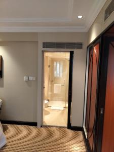 a room with a bathroom with a toilet and a shower at St. Mark's Hotel in Bangalore