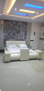 a room with a bed and two chairs in it at Gradun in Ikeja