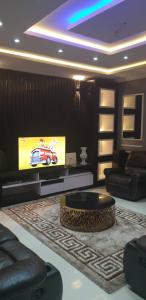 a living room with a tv and a couch at Gradun in Ikeja