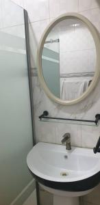 a bathroom with a white sink and a mirror at Gradun in Ikeja