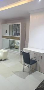 a white room with a chair and a desk at Gradun in Ikeja