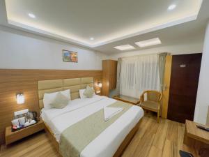 a hotel room with a large bed and a chair at Hotel Lee Green- best family hotel in Darjeeling in Darjeeling