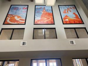 a row of five pictures on the ceiling of a building at Quality Inn West Medical Center in Amarillo