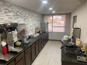 a large kitchen with a counter top in a room at Quality Inn West Medical Center in Amarillo
