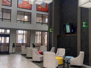 a lobby with a waiting area with chairs and tables at Quality Inn West Medical Center in Amarillo